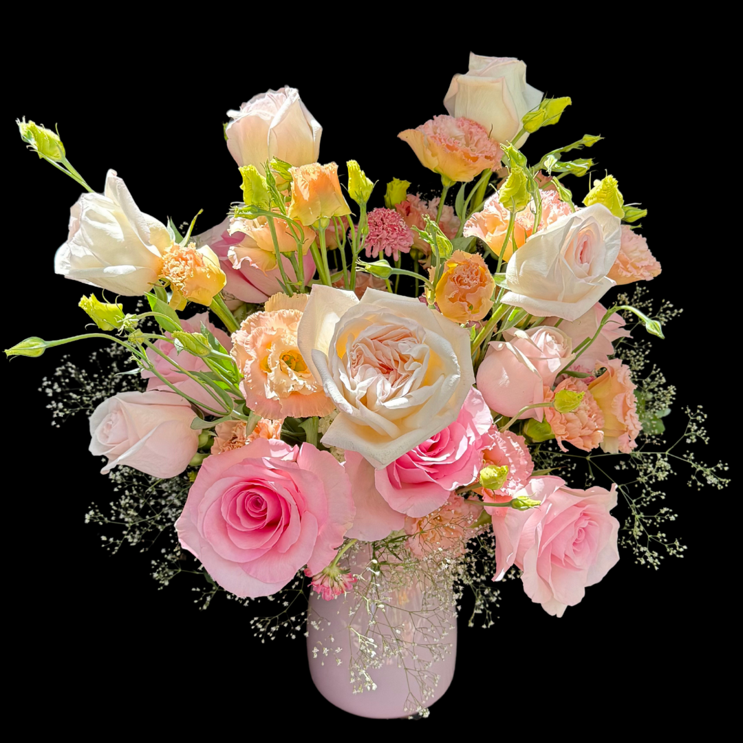 A hand-tied birthday bouquet with a variety of flowers including roses, lizianthus, carnations and seasonal blooms.