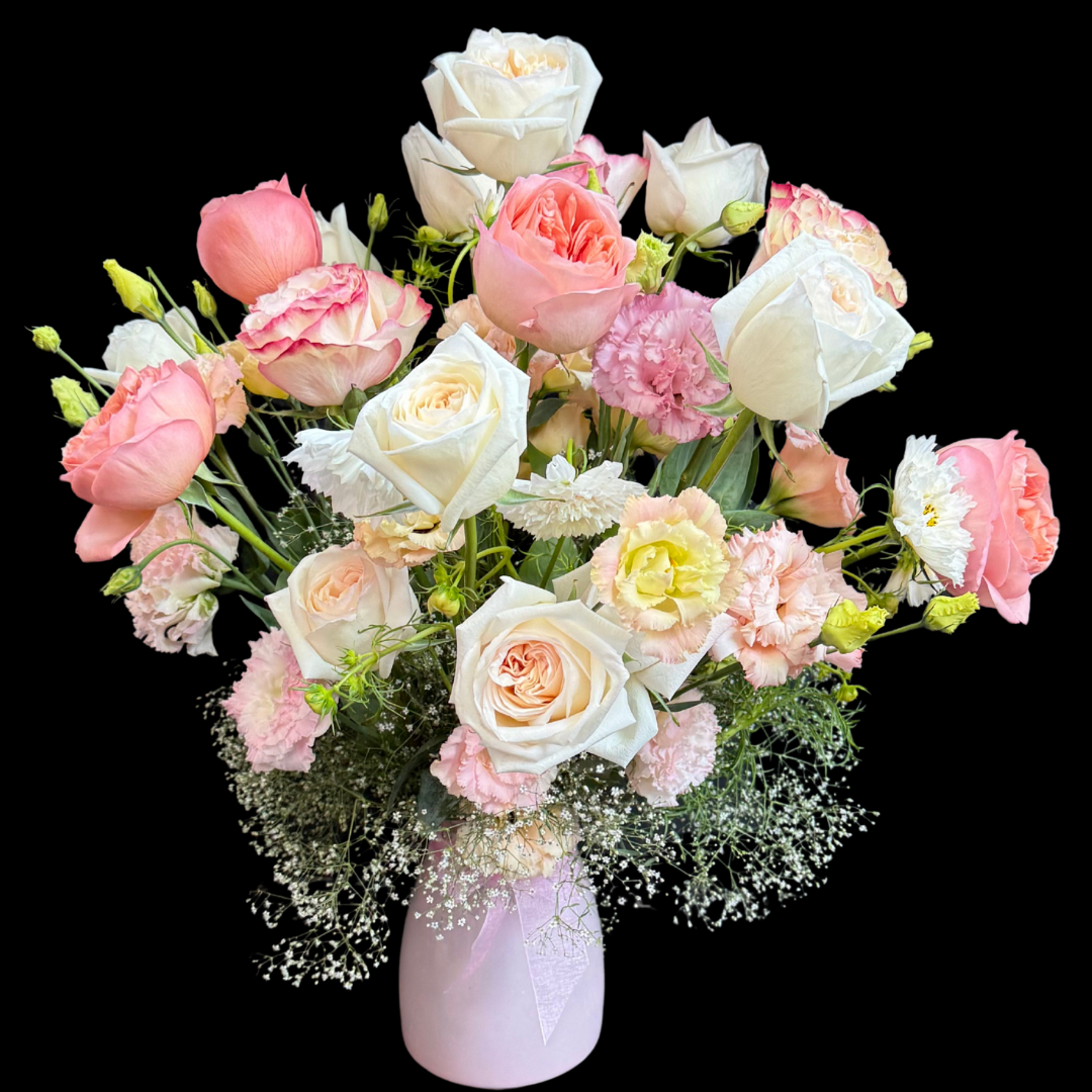 A hand-tied birthday bouquet with a variety of flowers including roses, lizianthus, cosmos and seasonal blooms.