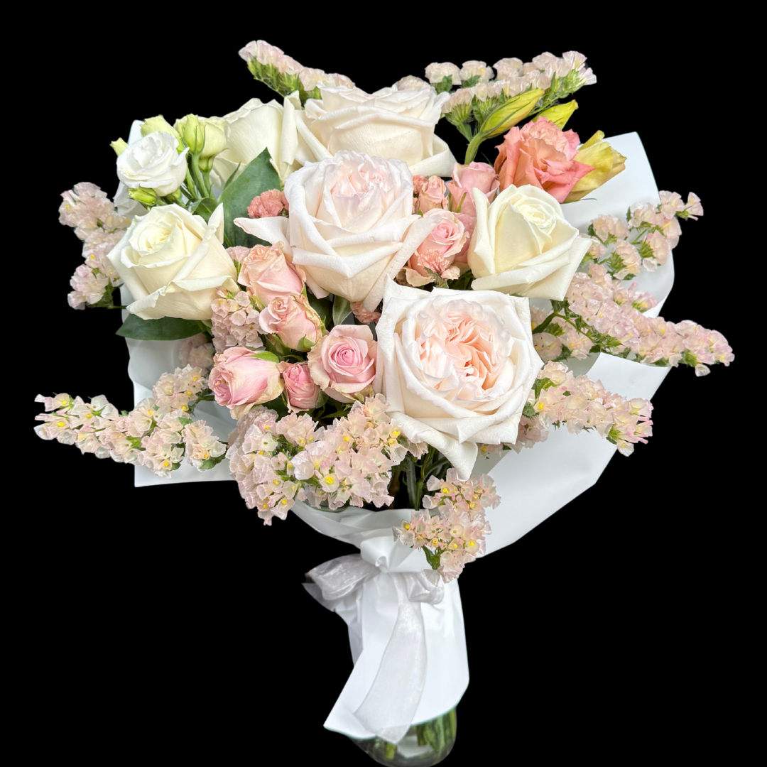 Bouquet of white  0'hara and pink roses with statice and spray roses at 
Toronto King West Luxury florist