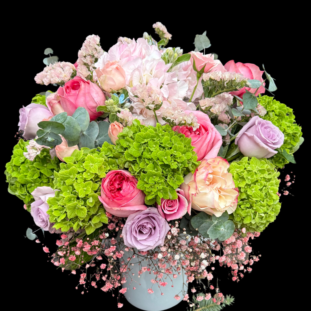 The most luxurious seasonal blooms - Pink garden roses, Ocean Song roses, hydrangeas and  status flowers in a vase.