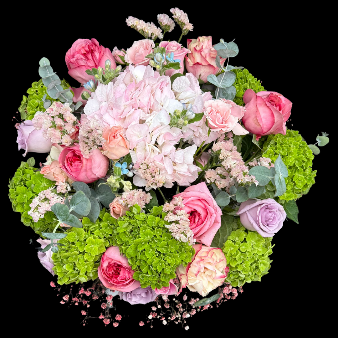 The most luxurious seasonal blooms - Pink garden roses, Ocean Song roses, hydrangeas and  status flowers in a vase.