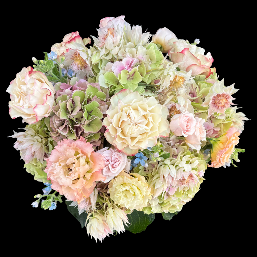 The most luxurious seasonal blooms -  garden roses, lisianthus, hydrangeas and blushing bride protea.
