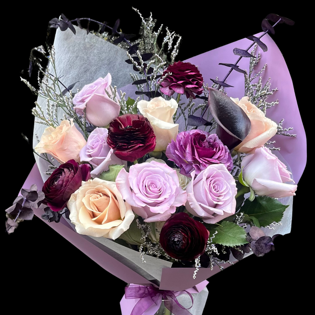 Elegant, luxury bouquet featuring burgundy calla lilies & ranunculus with quicksand, purple roses, and a touch of fillers perfect for Mother's Day, Birthdays and Valentine's Day.