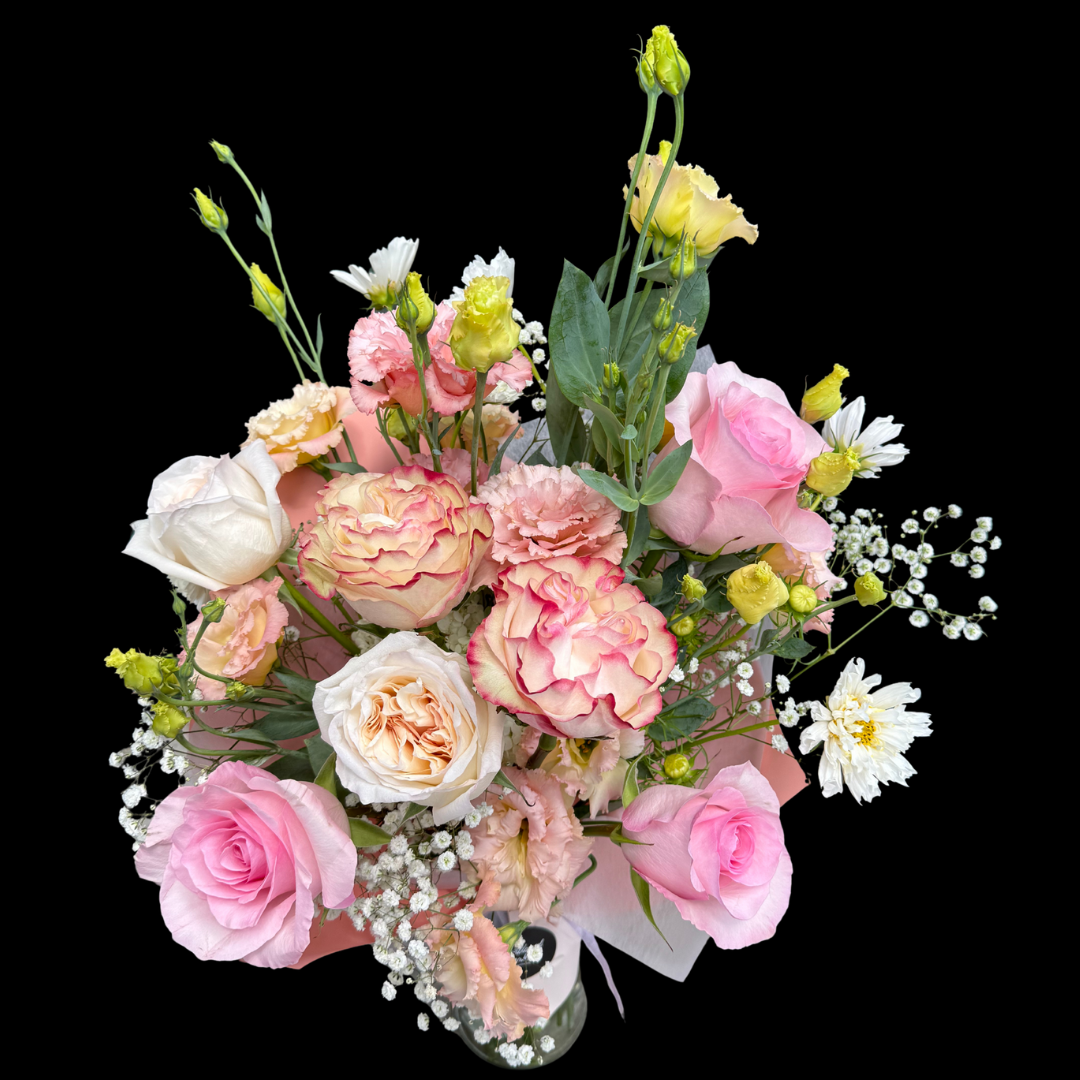 A hand-tied birthday bouquet with a variety of flowers including roses, lizianthus, cosmos and seasonal blooms.